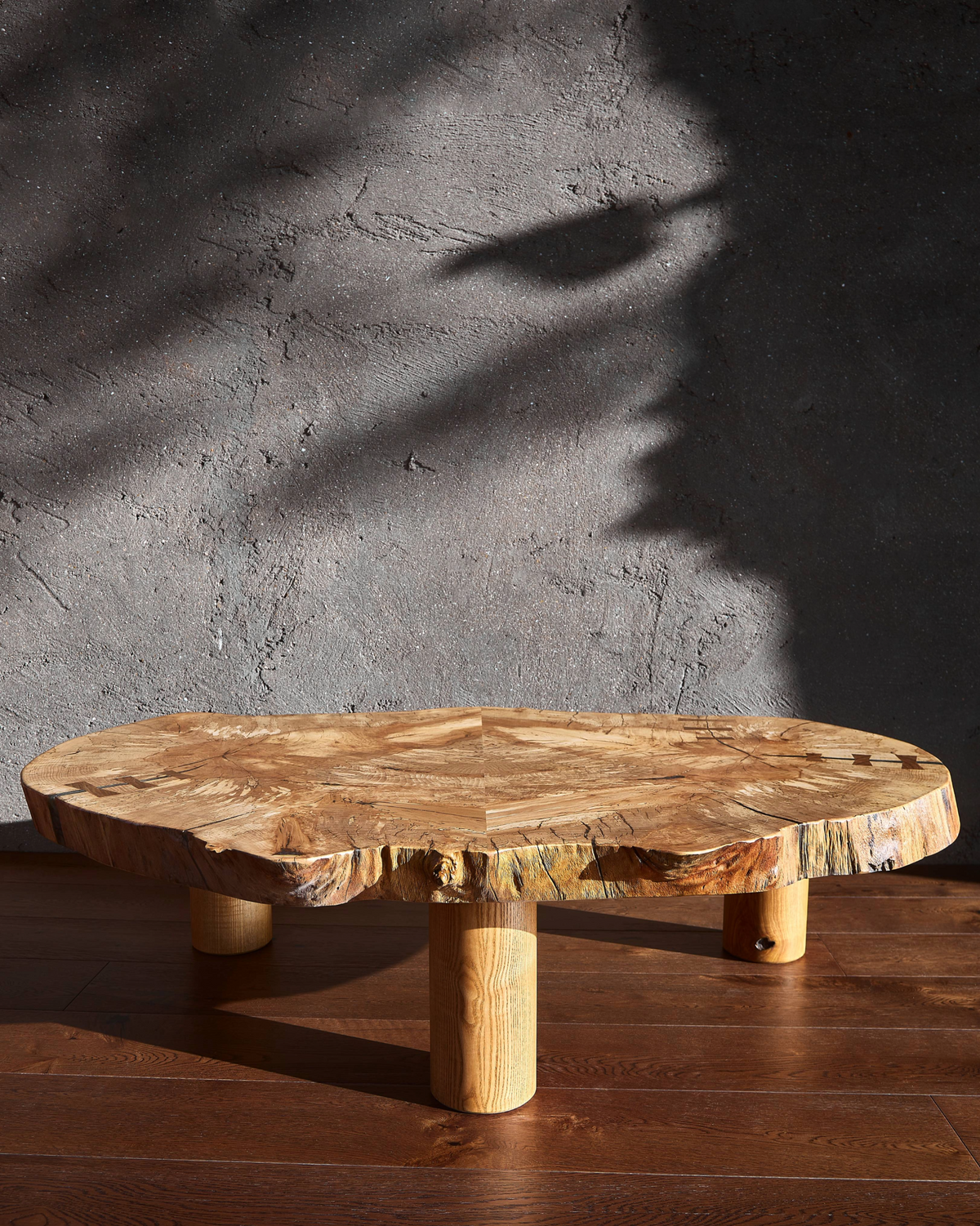 Book-matched spalted beech grain on the Cocoon Table, showing symmetrical patterns and natural live edges against a minimal background. 