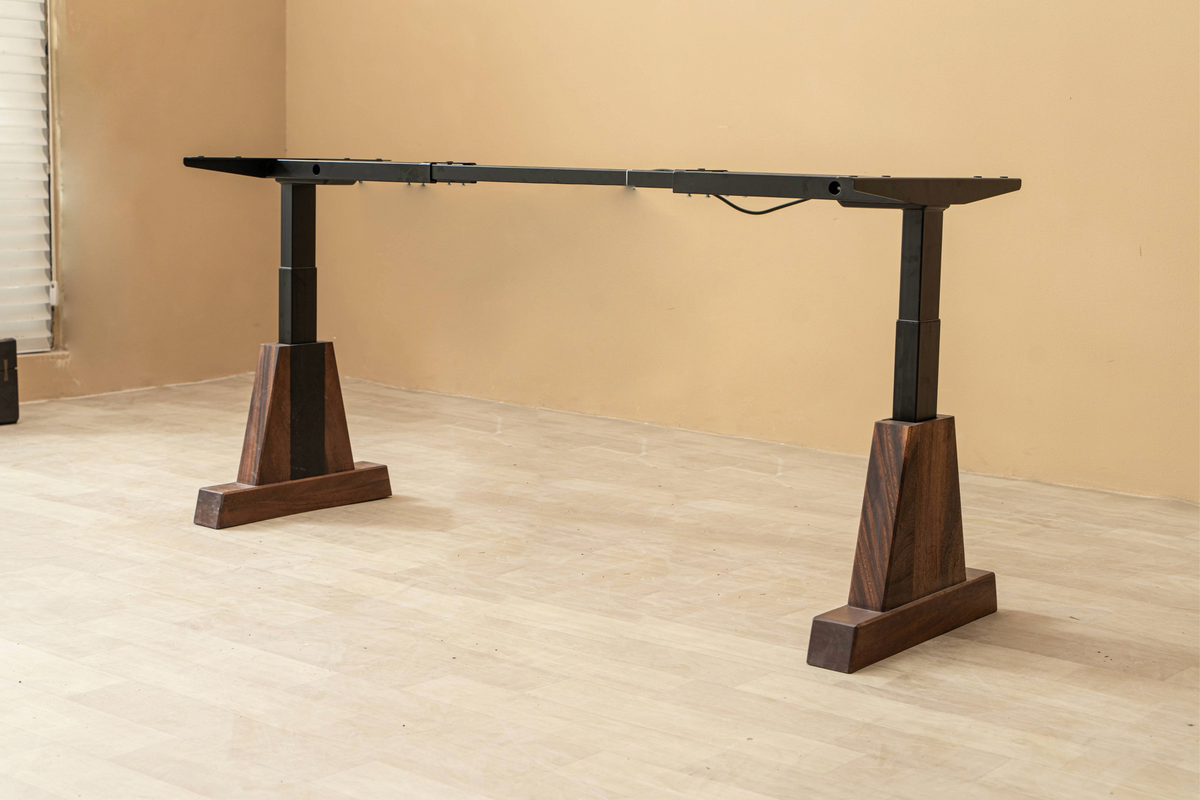 The Axiom Stands at an angle, showcasing black walnut construction and adaptable table base design.
