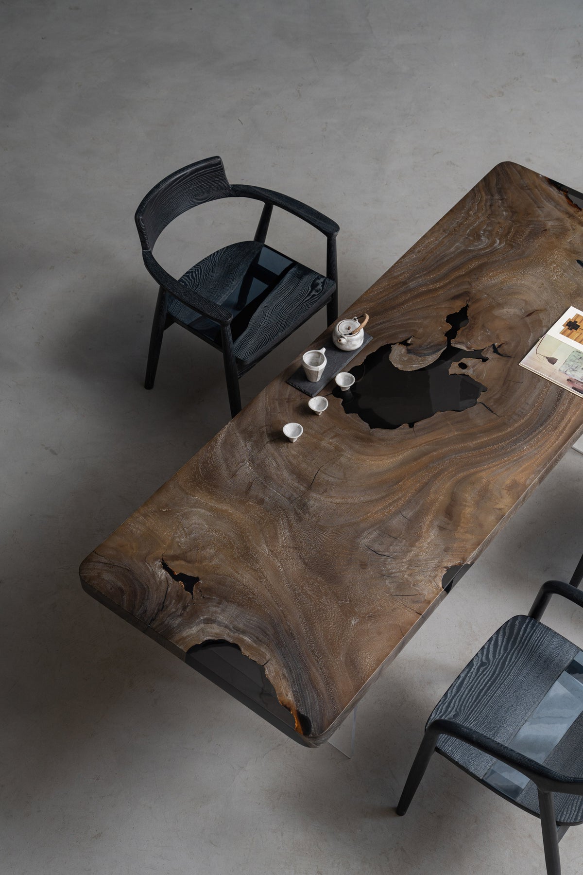 Three quarter view of Basin Meridian rainwood dining table showing live-edge contours, by Woodslabs.