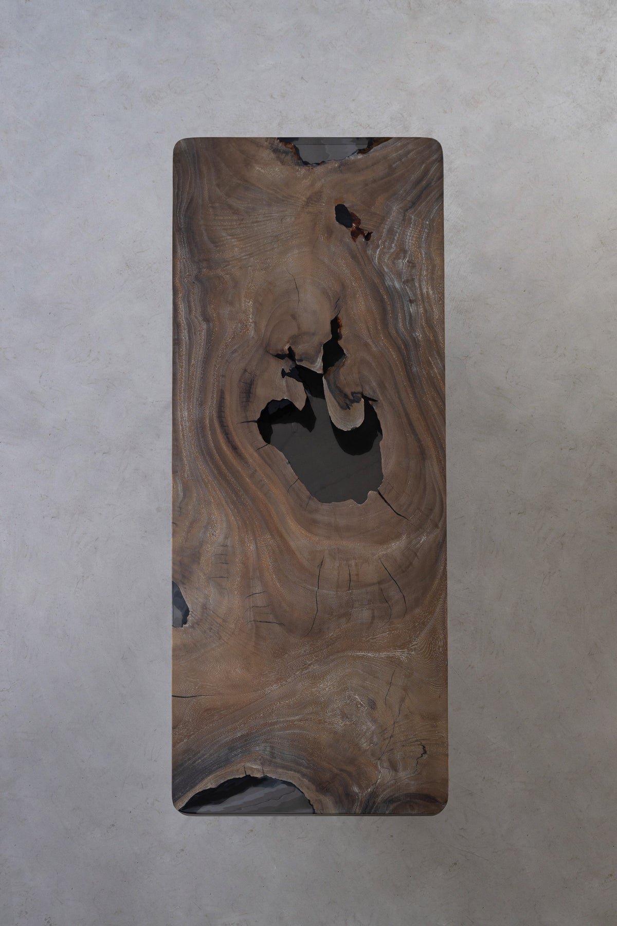 Full top view of Basin Meridian rainwood dining table showing live-edge contours, rich grain flow, underside of table.