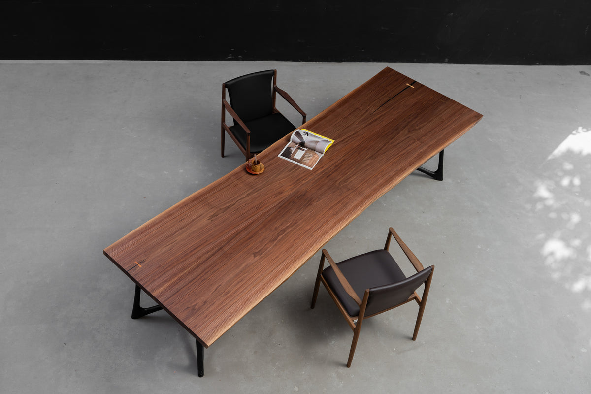 High-angle perspective of the 3.2m Duskwood Bridge live edge walnut dining table, solid wood slab.