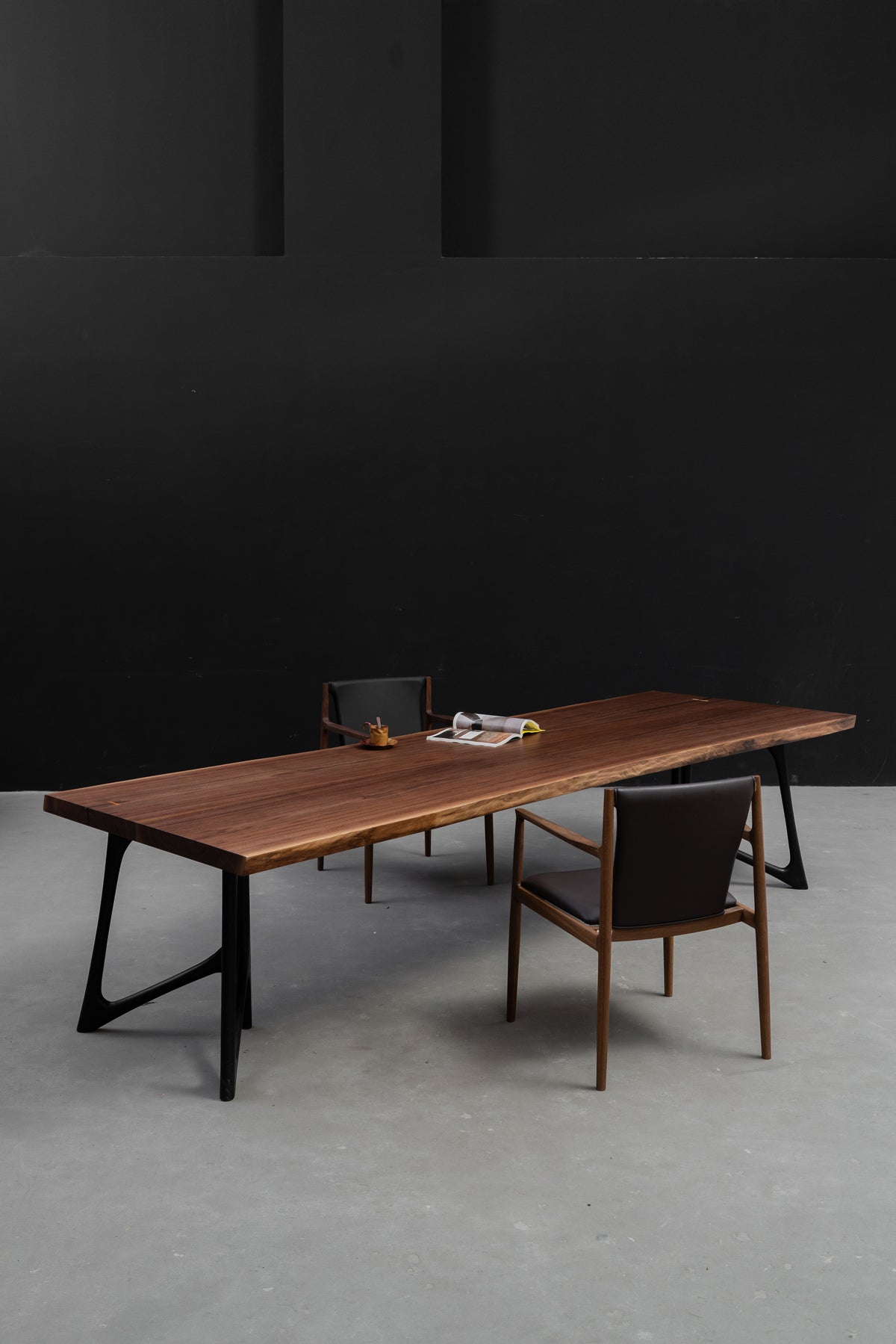 Portrait shot of Duskwood Bridge live-edge black walnut table, 5.4cm thickness and 320cm length, premium light-brushed surface texture.