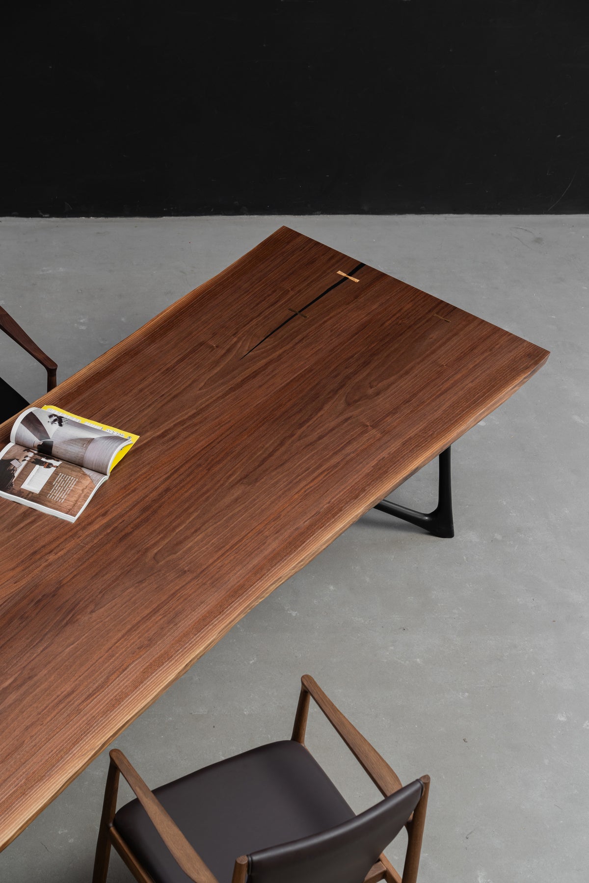 Three quarter detailed view focused on the heartwood black walnut symmetry and  live edge slab.