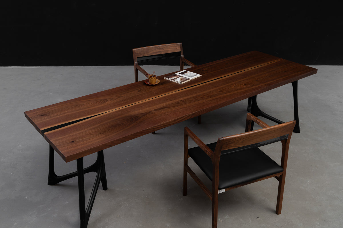 Wide angle full view of the Duskwood Vault table in black walnut by Woodslabs, showcasing luxury grain and presence.