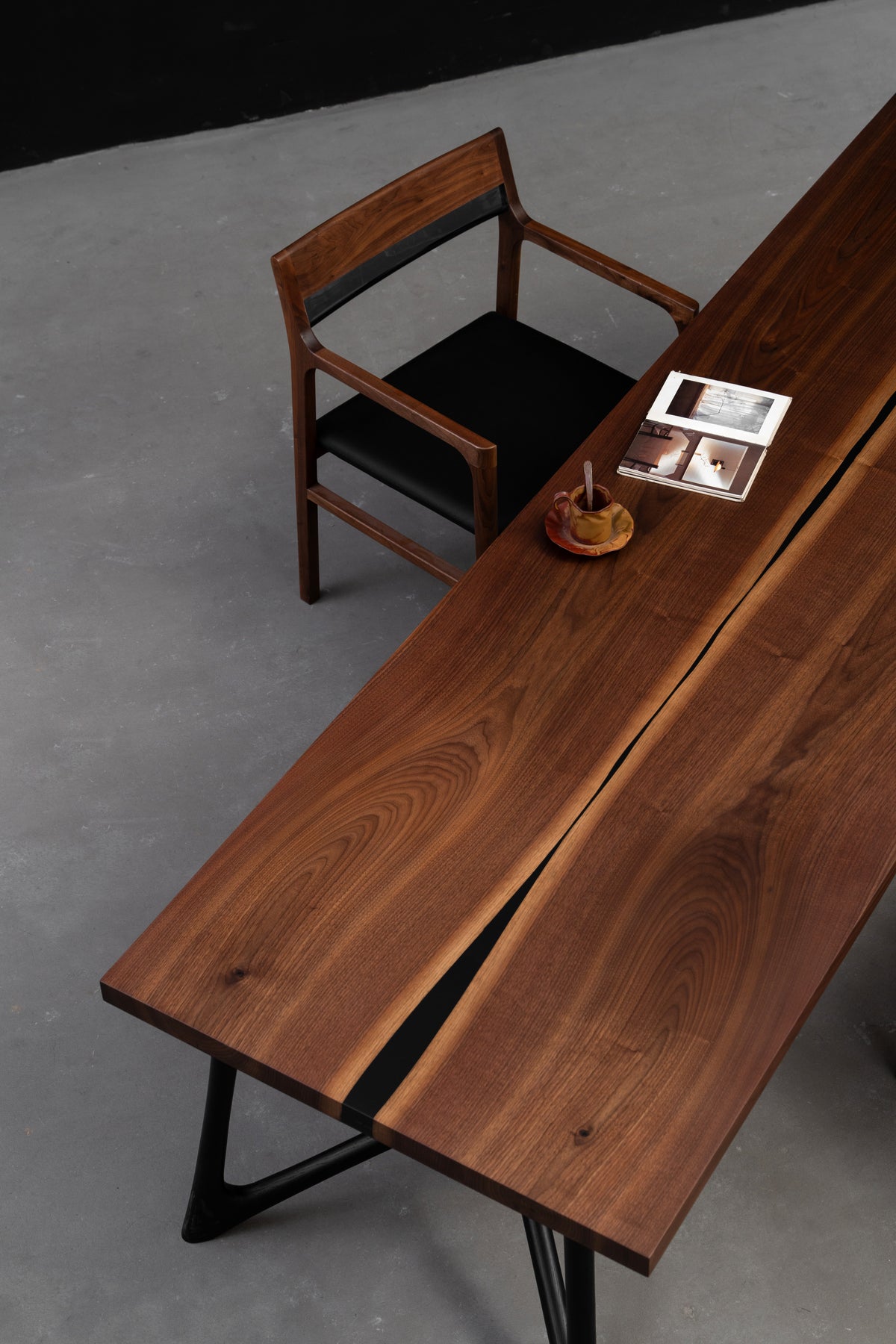 Three quarter overhead view of the 2630mm x 820mm Duskwood Vault walnut table showcasing symmetrical cathedral grain.