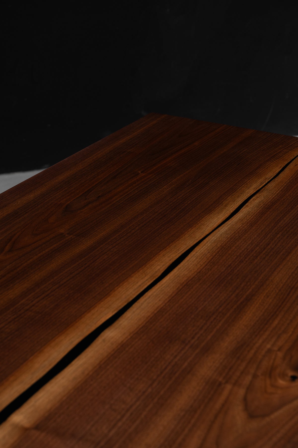 Detailed shot of the precision joinery live edge book-matched Duskwood Vault table, solid wood slab.