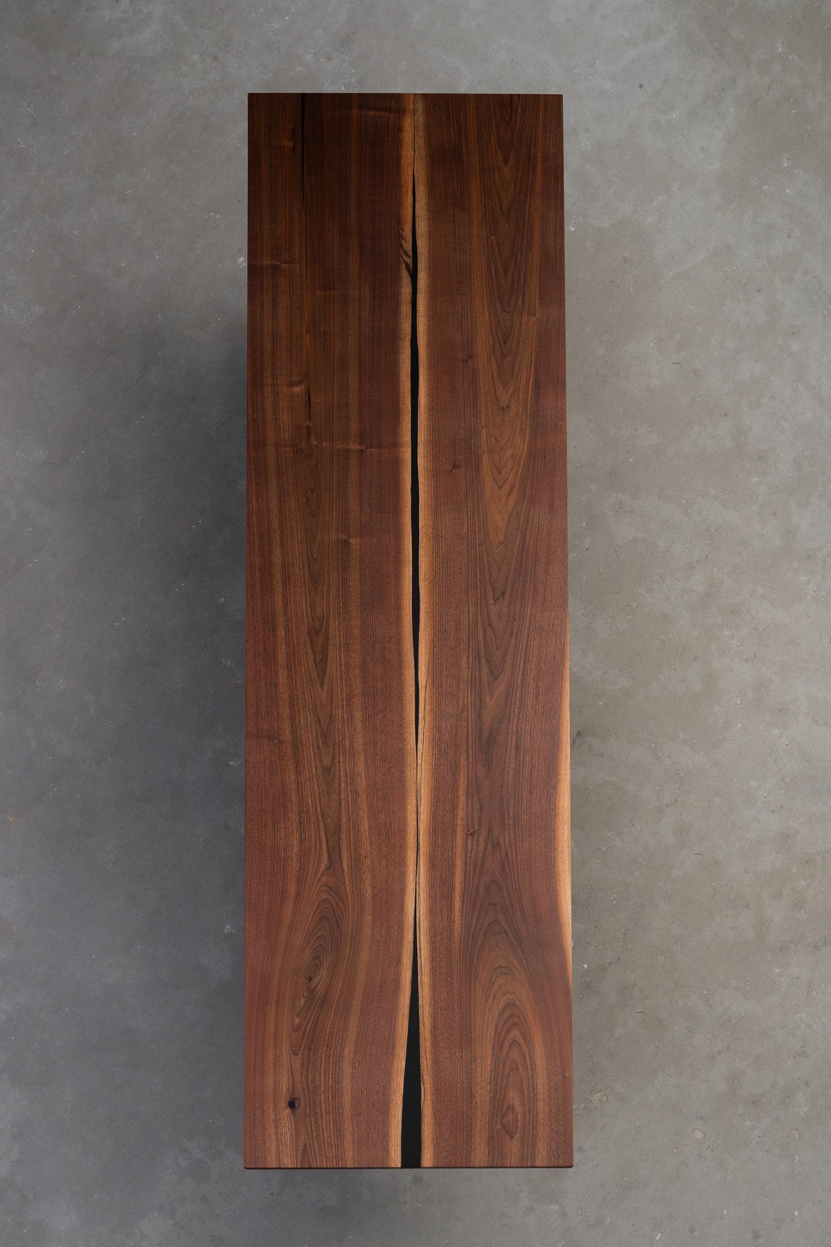 Full-length view of the 60kg solid walnut Duskwood Vault table, vertical image showcasing black walnut grain and resin feature.