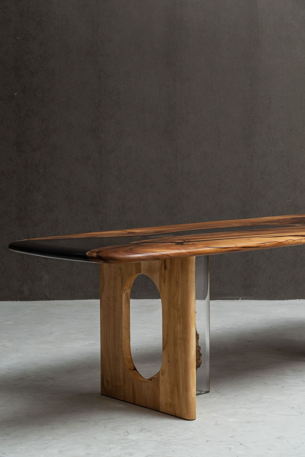 Pillars of Symposium French poplar base supporting a live-edge dining table, showcasing sculptural form and natural wood grain