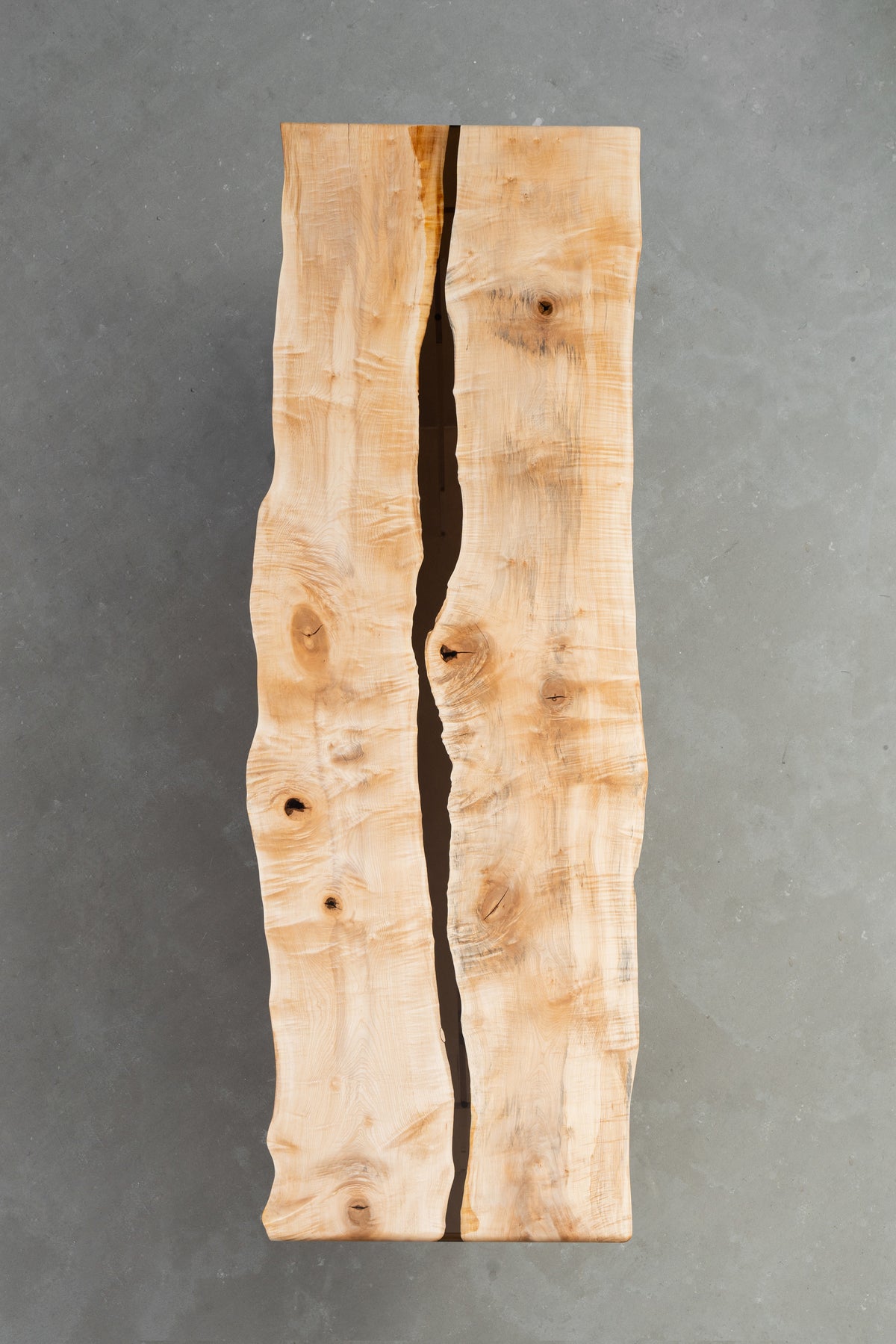 Underside view of Japanese Tochi live-edge table showing solid slab construction