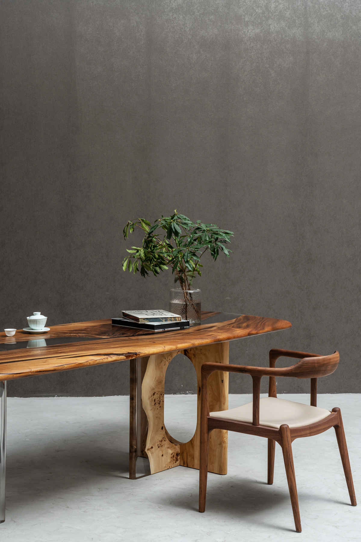 Angled view of poplar wood table base with clear resin panels and sculptural oval opening