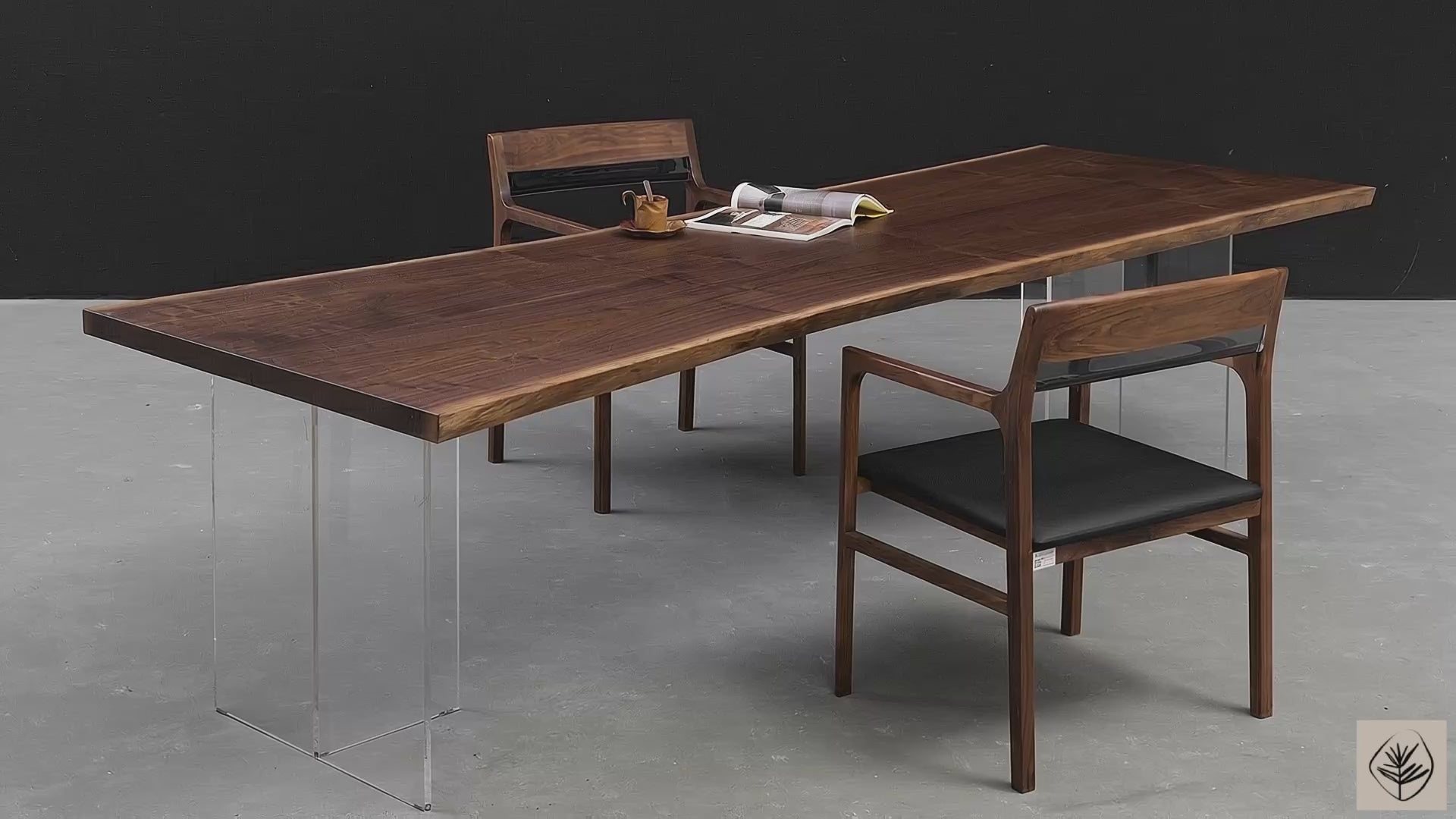 Full table overview of black walnut live edge table on transparent resin legs in studio setting