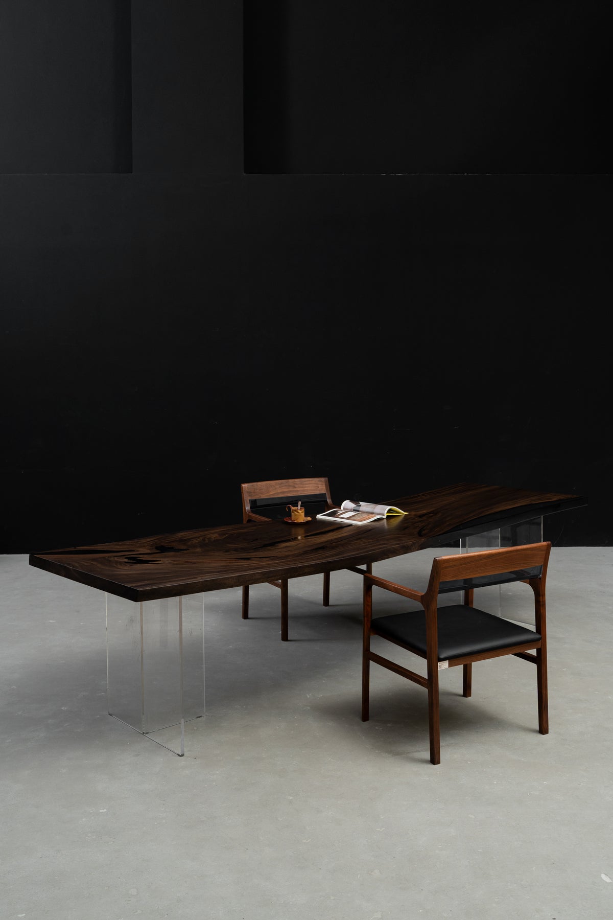 Rainfall Meridian rainwood dining table in architectural interior setting, long curved live edge slab with resin detail