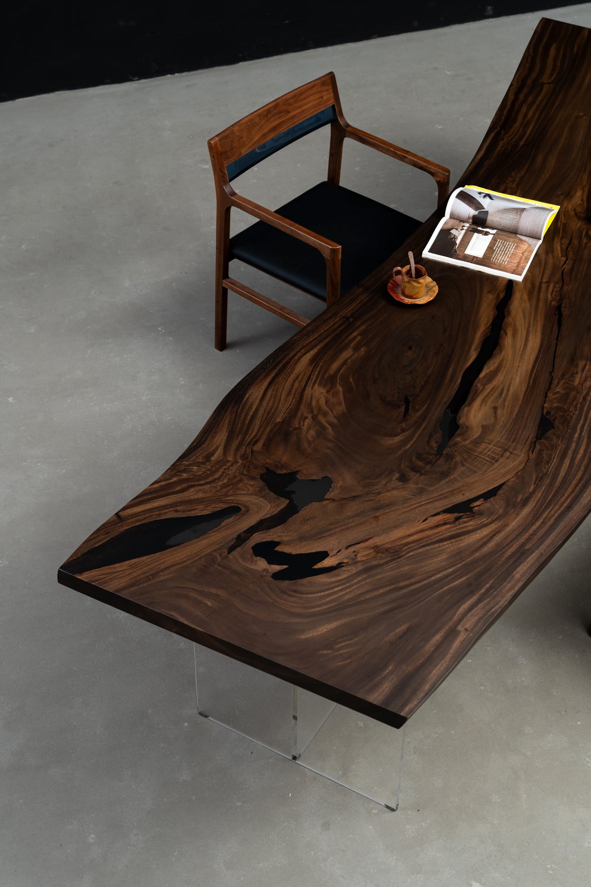 Three-quarter view of Rainfall Meridian live-edge rainwood dining table with resin details
