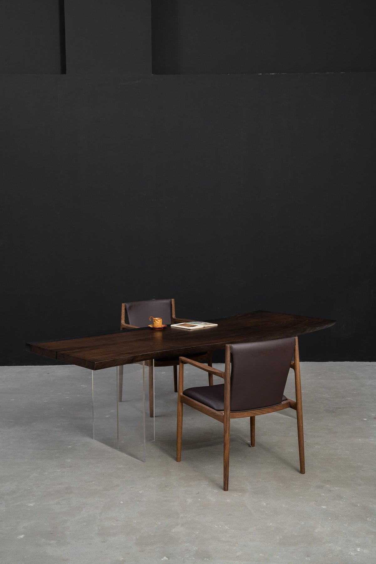 Meridian Shores live-edge rainwood dining table styled in minimalist interior with translucent resin edge