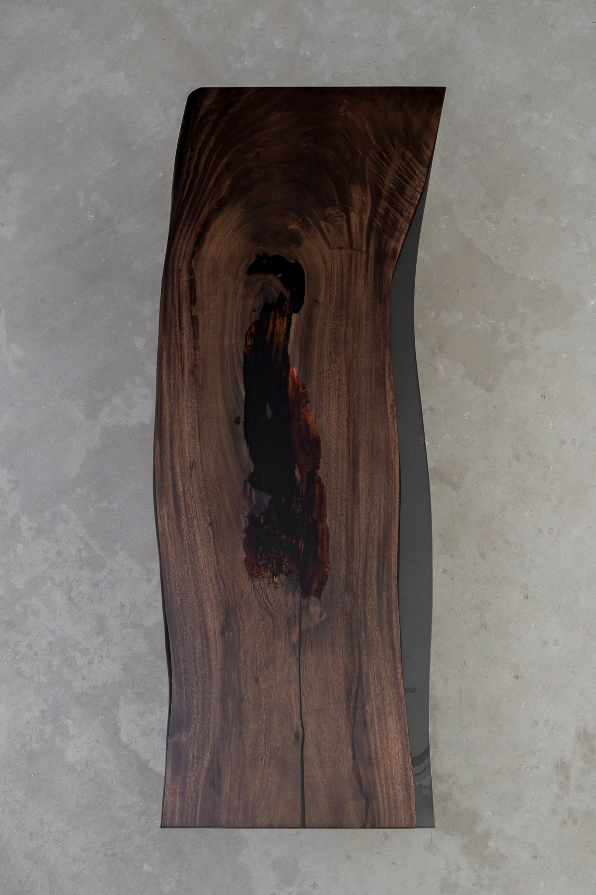 Overhead view of Meridian Shores rainwood dining table underside with smooth translucent resin finish