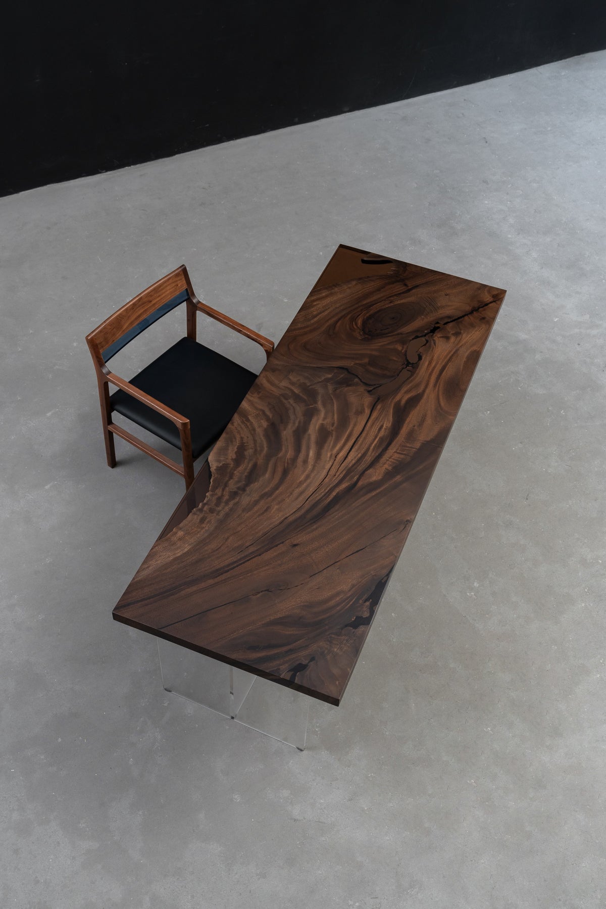 View of the Meridian South Current rainwood dining table showing its complete live-edge form and balanced proportions.