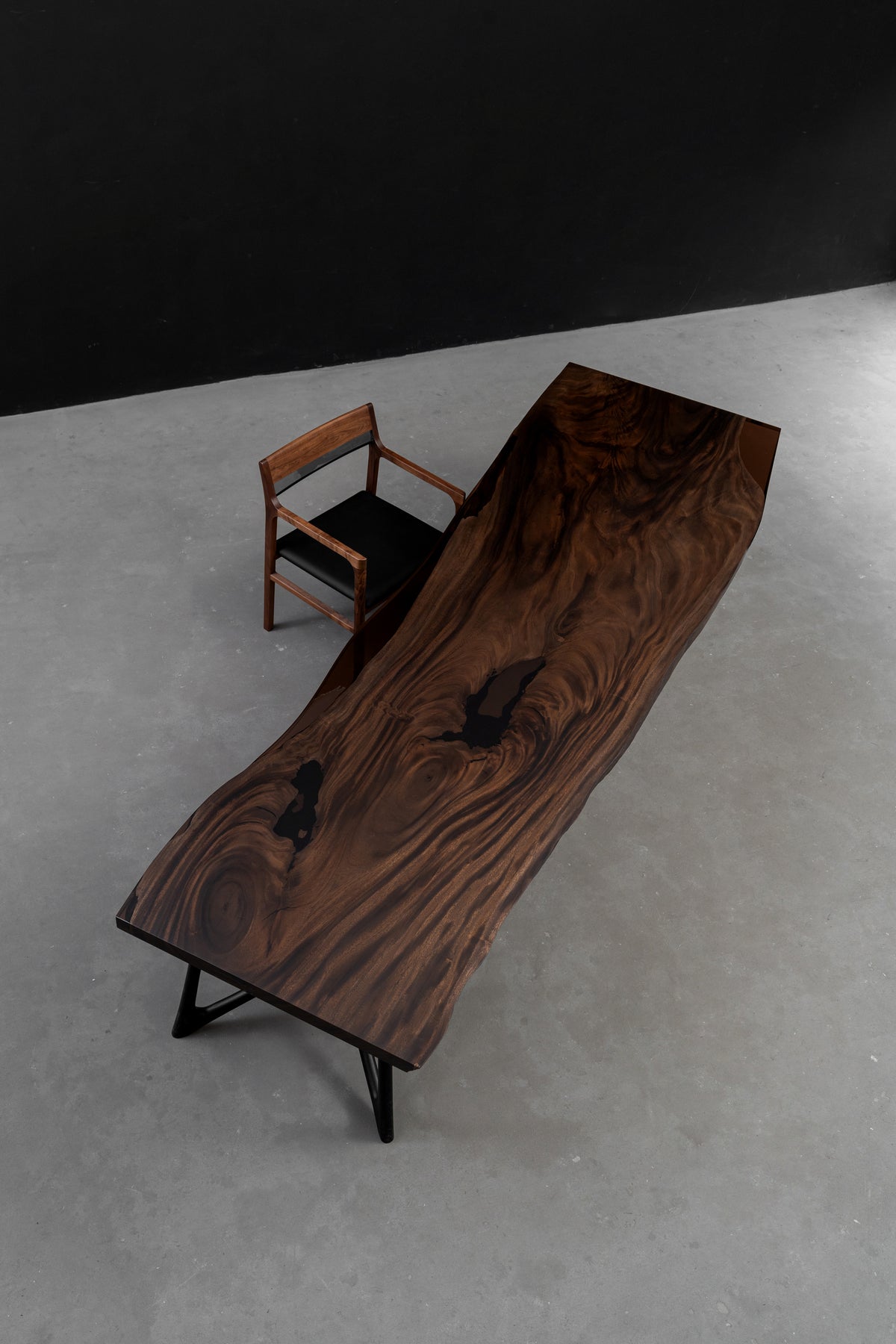 Overhead contextual view of the Southern Lines Meridian dining table, showing proportions, and sculptural presence.