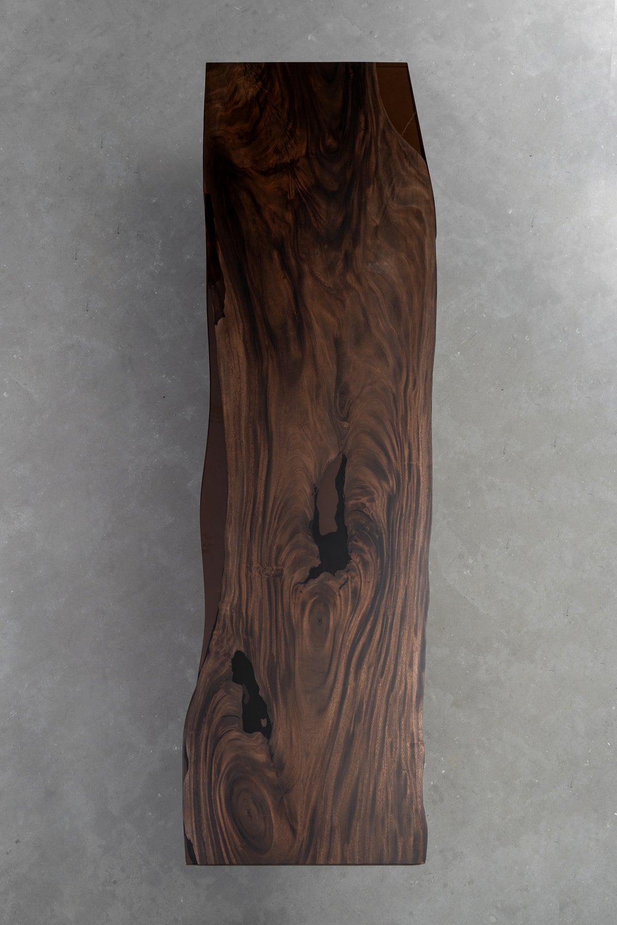 Vertical slab view of the Southern Lines Meridian rainwood table highlighting natural edge profile and grain continuity.