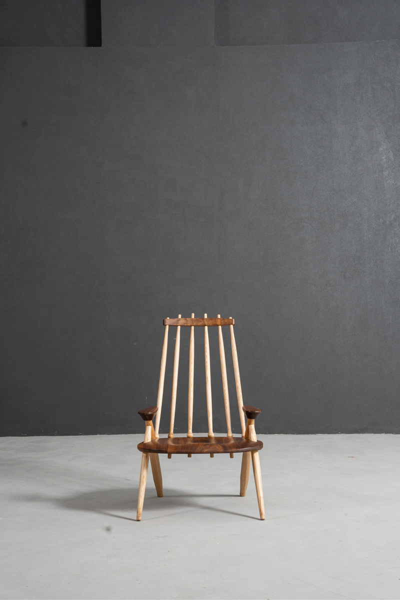 Front view of the Arcadia Chair showcasing its black walnut frame and ash wood spindle back.