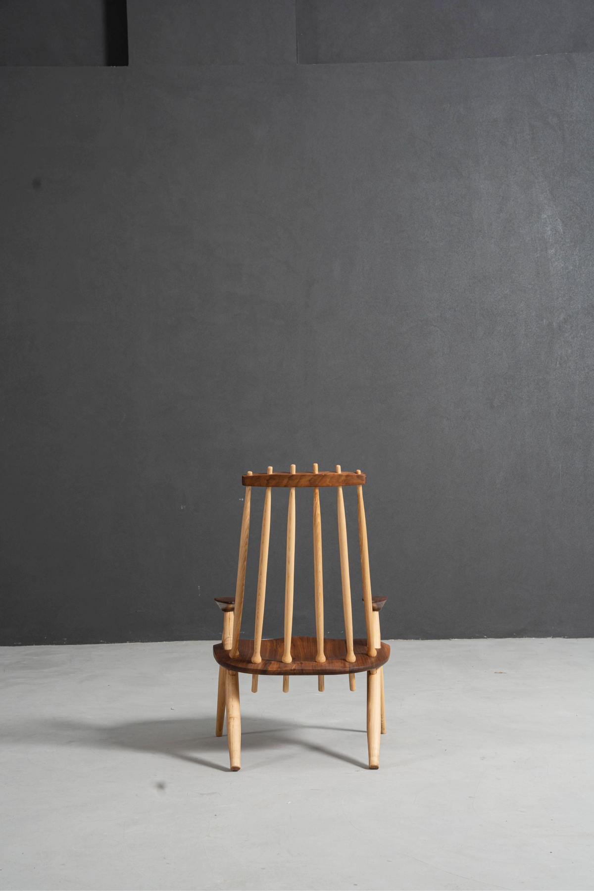 Rear perspective of Arcadia Chair highlighting ergonomic ash spindles and walnut frame.