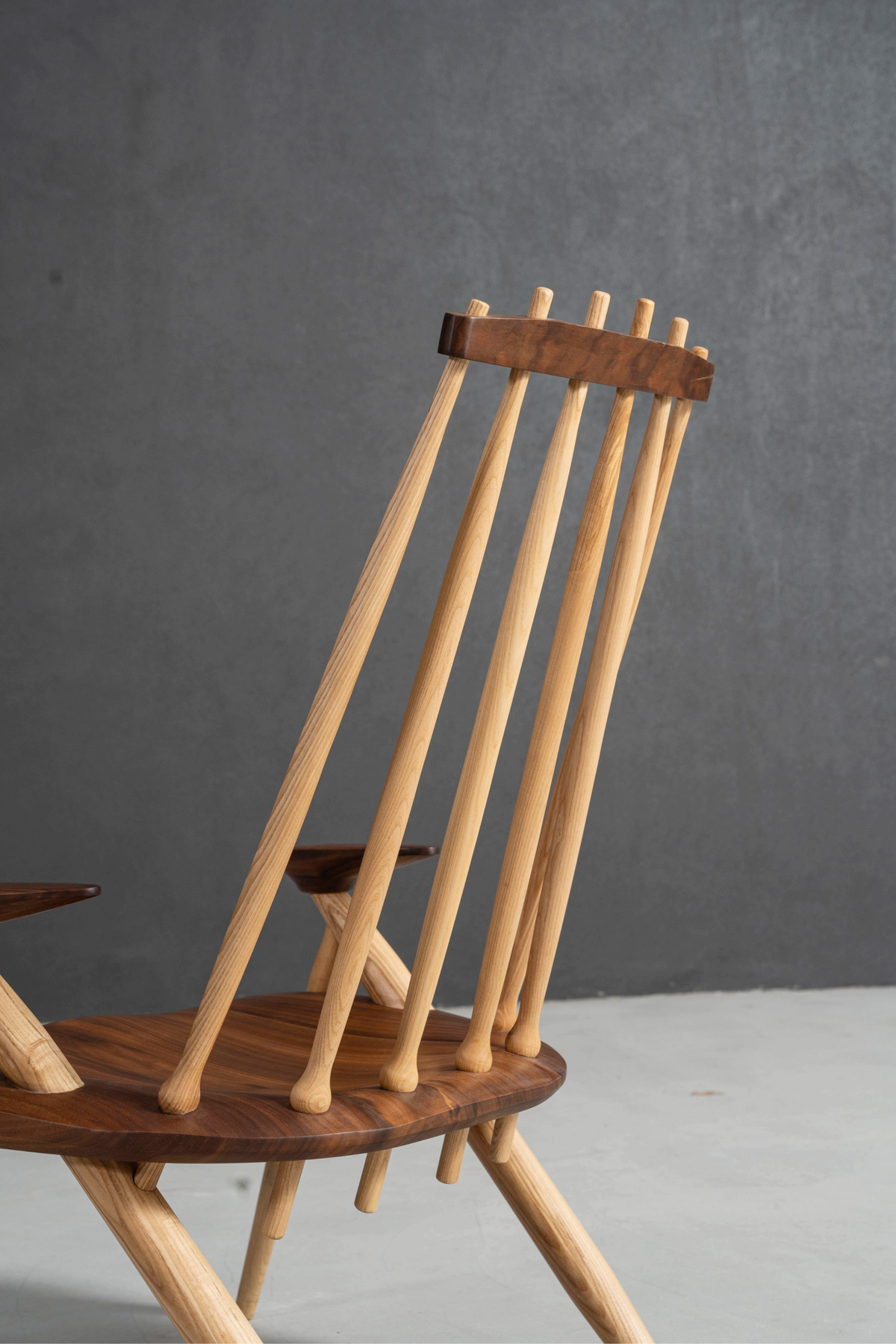 Close-up of Arcadia Chair's back frame and seat connection, showcasing wood joinery.