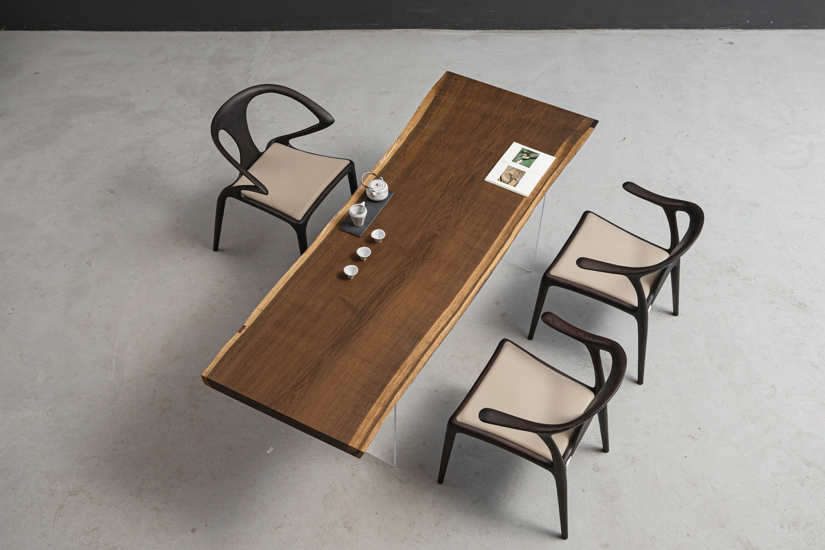 Angled view of live edge wood table emphasising organic edge flow, balanced proportions, and sculptural presence