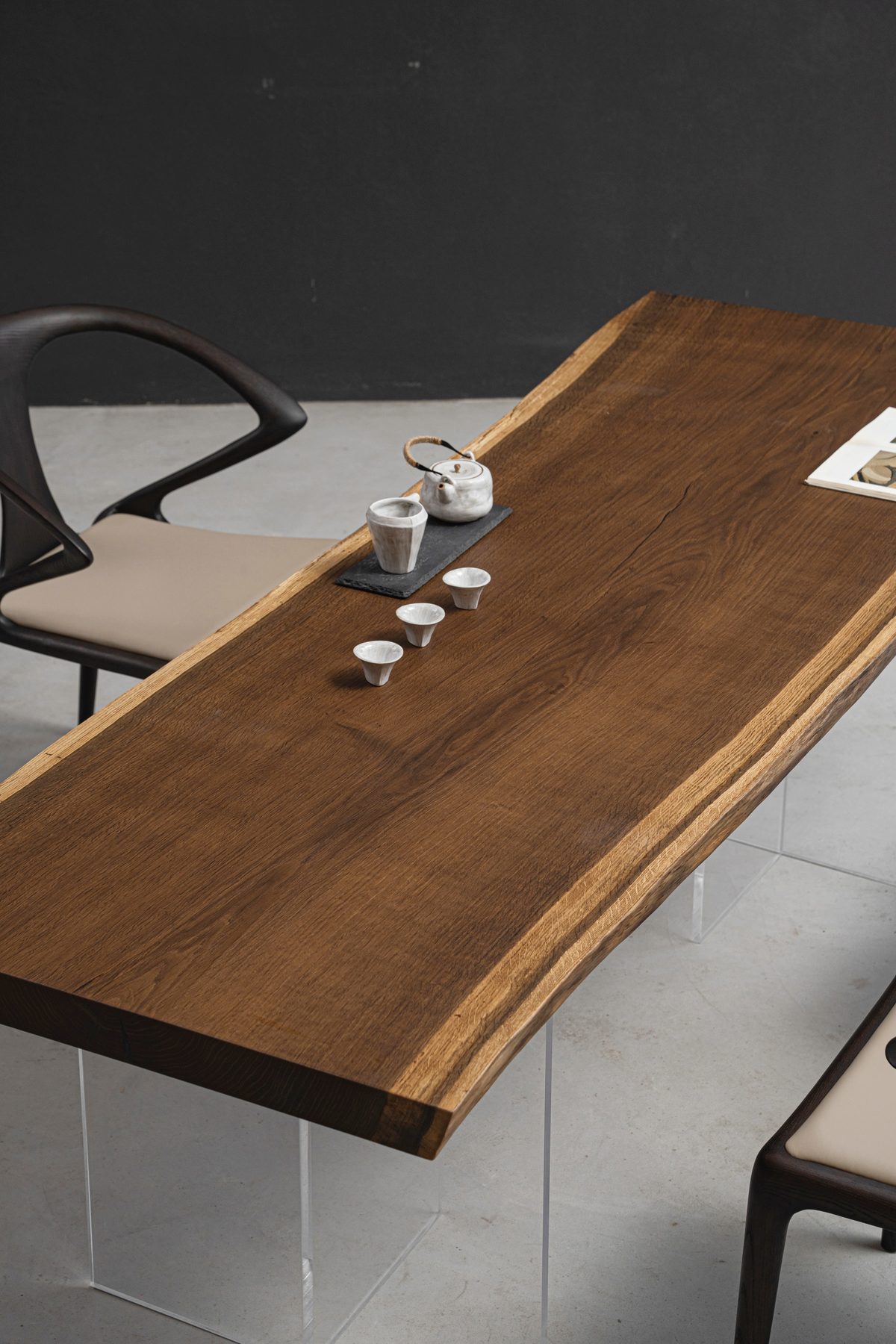 Live edge wood dining table with sculptural form, natural organic edge, and clearly visible solid wood grain