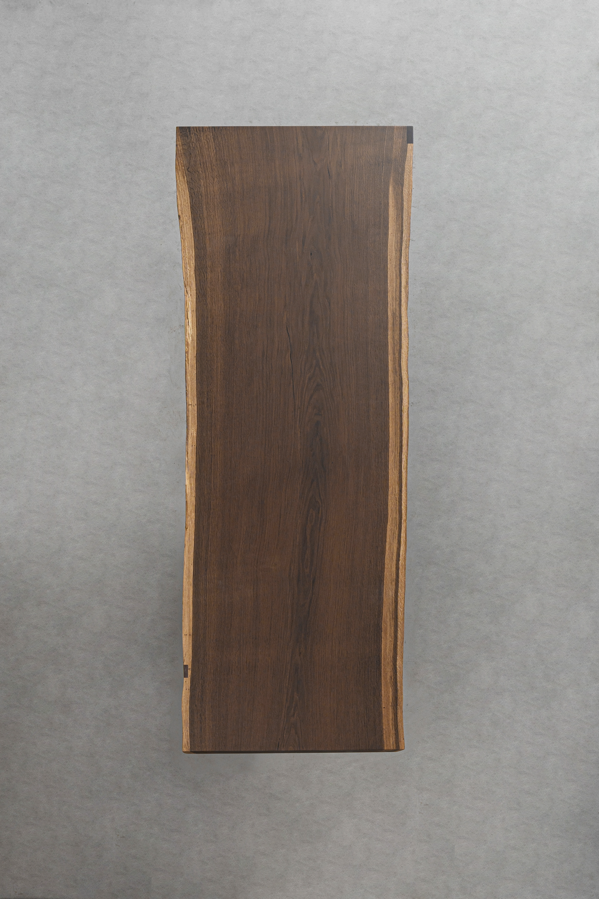 Top-down view of Aureole Table highlighting the smoked oak's deep grain and organic contours.