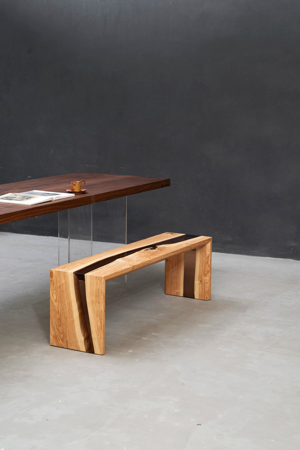 Bridge of Stillness Bench in minimalist setting with complementary table.