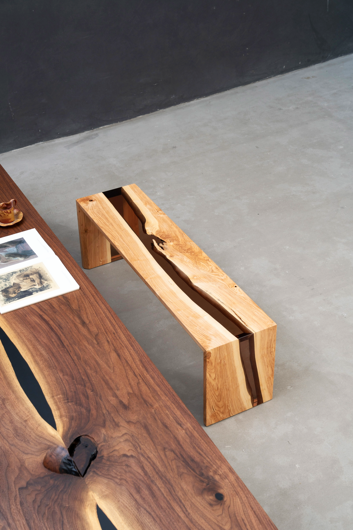Overhead angle showing epoxy resin and natural live edge in bench-table composition.