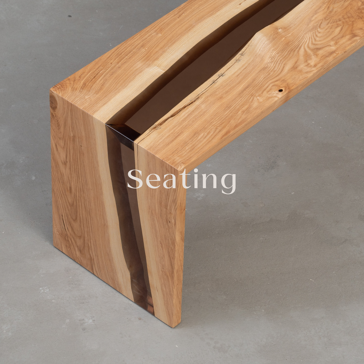 The Bridge of Stillness bench stool, crafted from ash wood with an earthy tone, featuring smooth wood slabs and accents of ice resin. The minimalist design offers a calming, natural aesthetic, perfect for seating in serene, modern spaces.