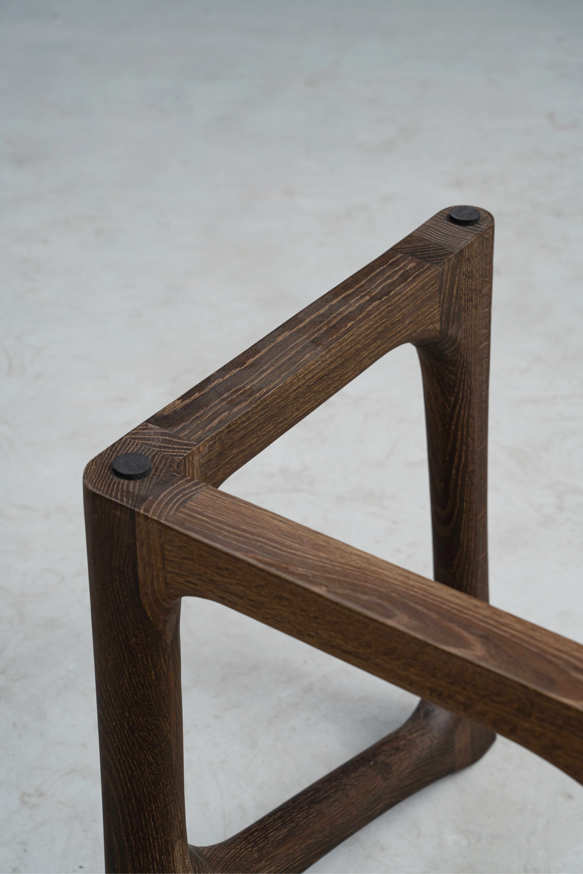 Butterfly joint edge detail in smoked oak, showcasing precise wood inlay and craftsmanship.