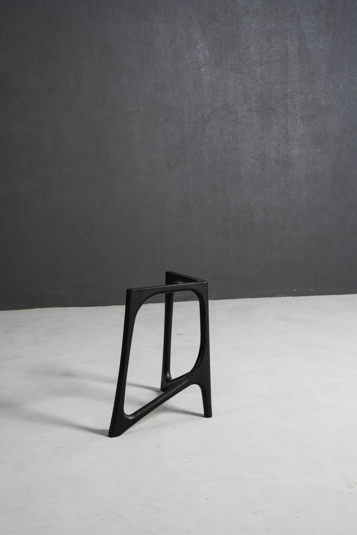 Single black stained oak Butterfly Effect T-Stand from a pair, isolated product shot showcasing its sculptural form.