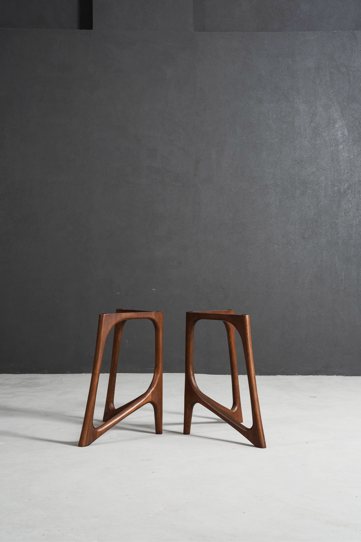 Portrait shot of Butterfly Effect V-stand table base featuring mirrored V forms and strong architectural support