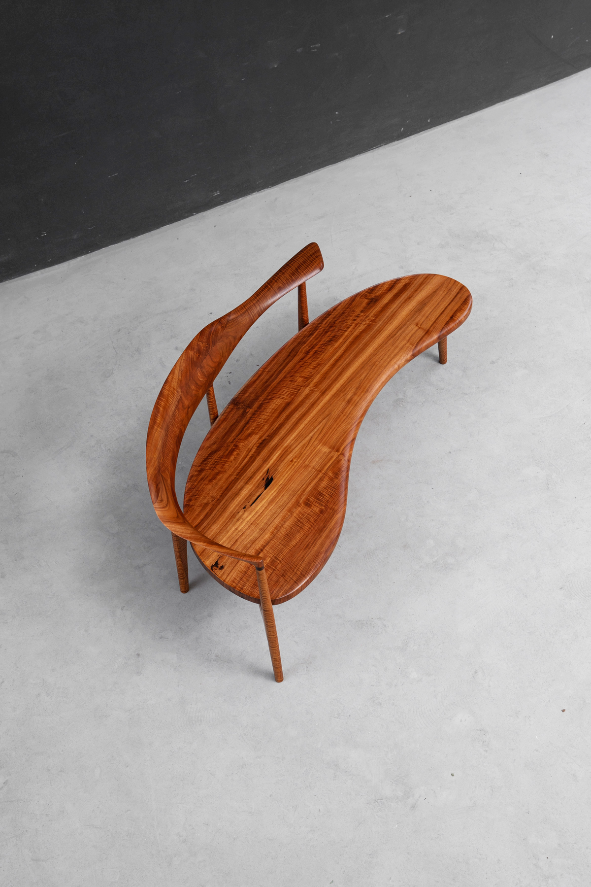 Overhead shot of Confluence Chair's shared seating design in luxurious Indian rosewood.