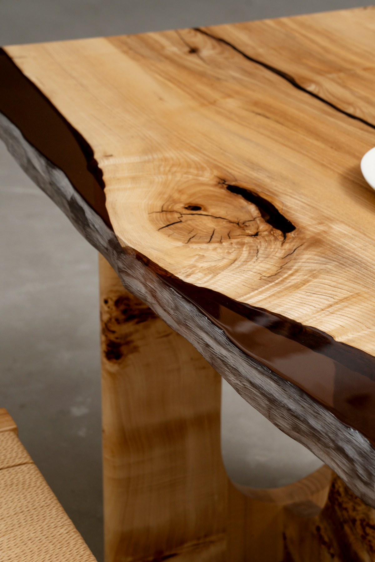 Convergence table highlighting translucent resin flow integrated into solid wood, revealing depth, grain movement, and precision finish