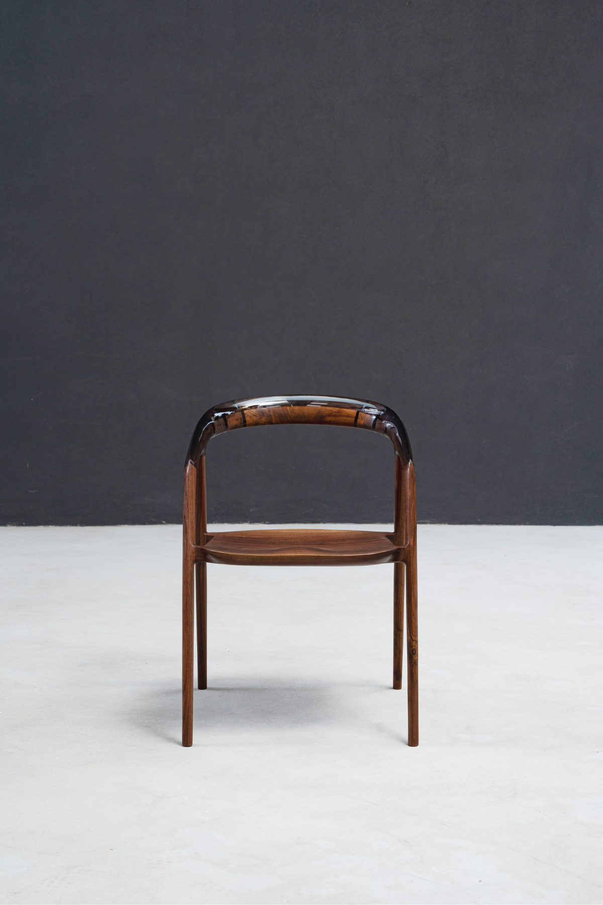 Clean front profile of Event Horizon Chair highlighting its sculpted wood and resin form.