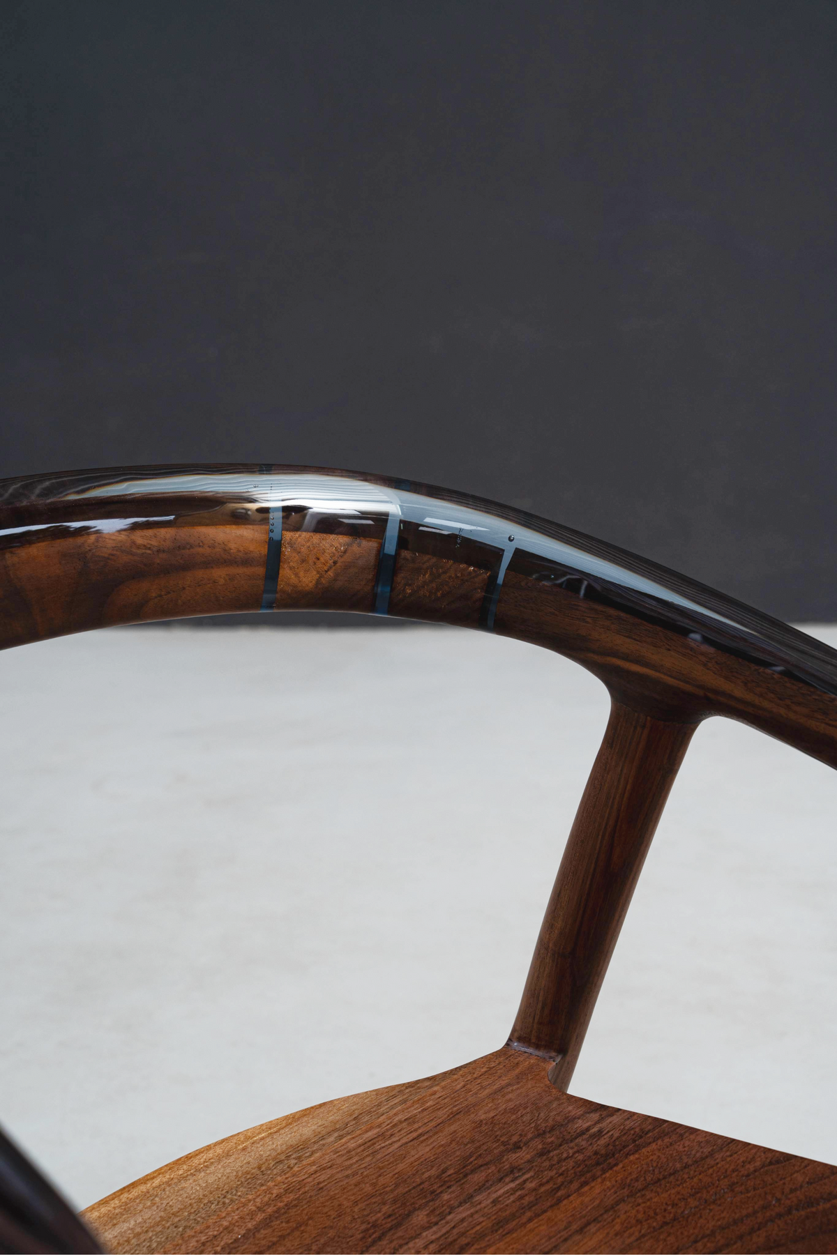Detailed view of epoxy and walnut integration on Event Horizon Chair's backrest design.