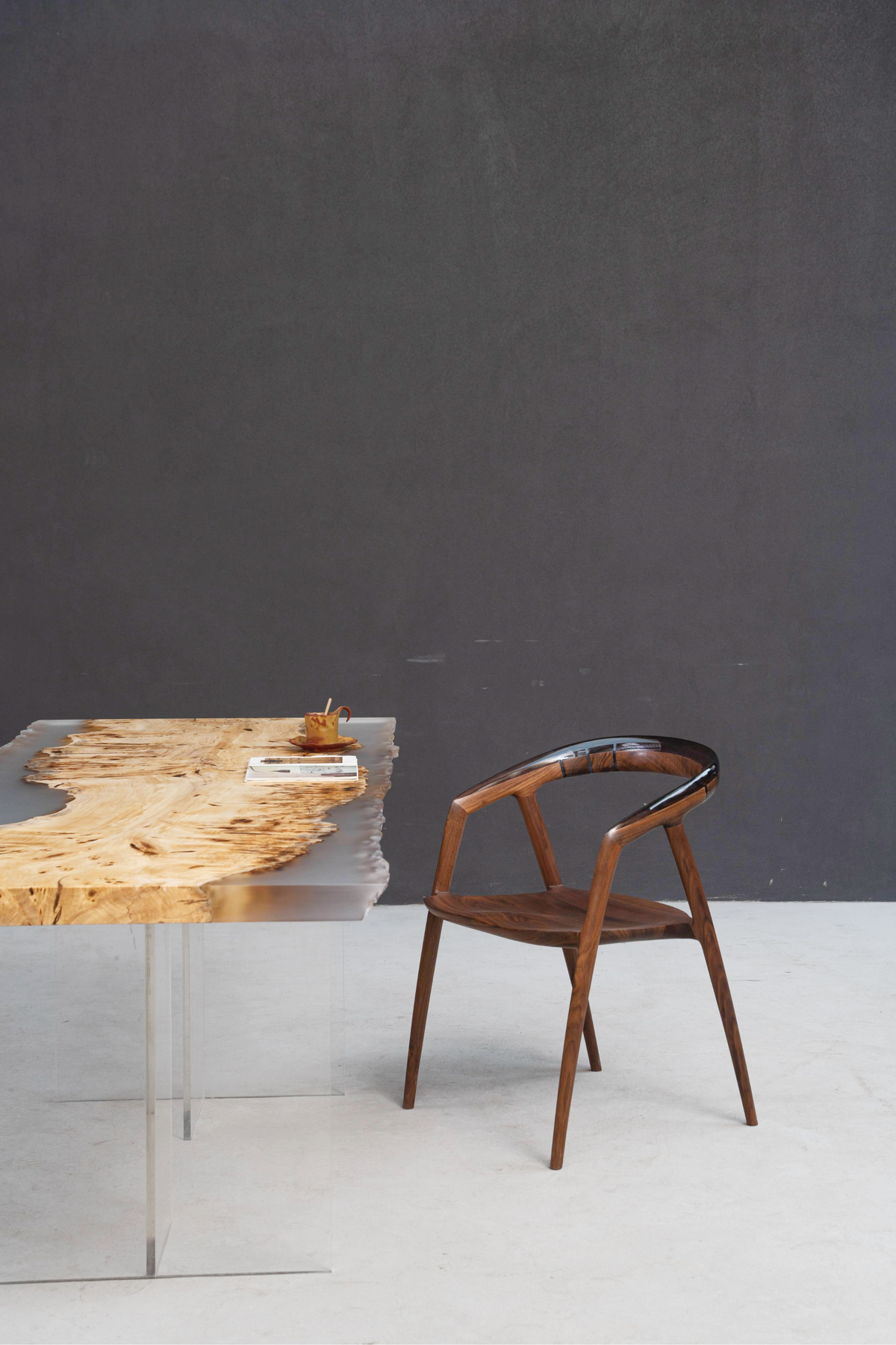 Styled scene with crystalline Clarity Prism Table and wood-resin Event Horizon Chair.