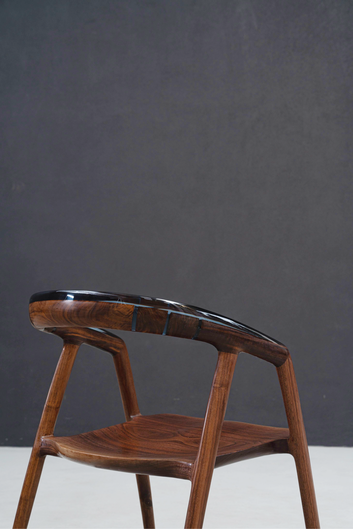 Event Horizon Chair showcasing seamless integration of wood and epoxy in seat and backrest design.