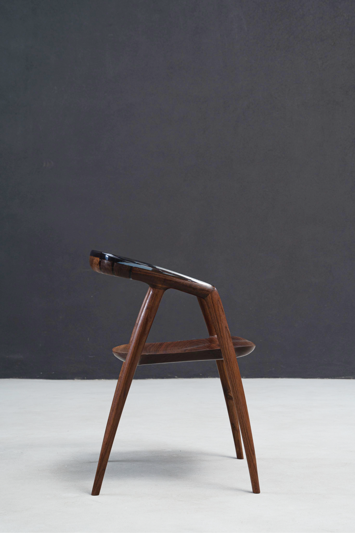 Complete side elevation view of the Event Horizon Chair highlighting its elegant form and lines.