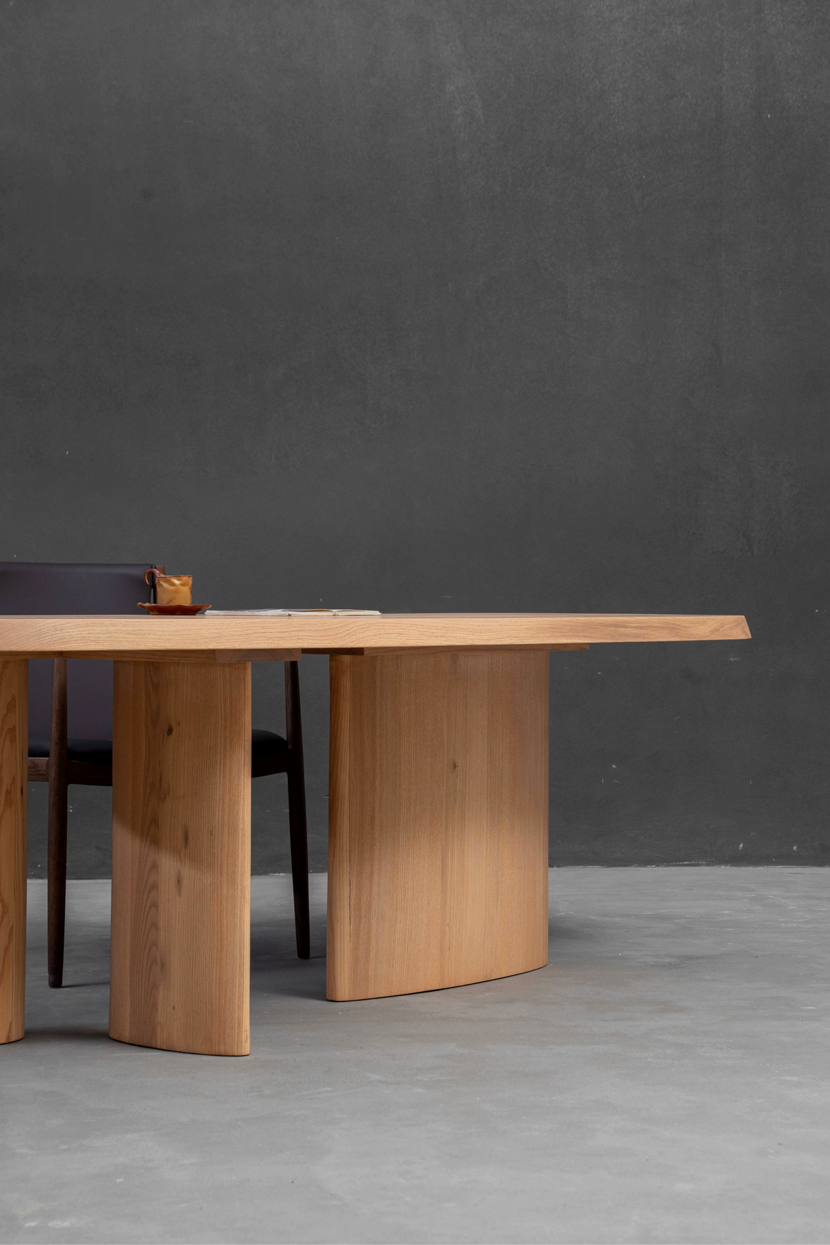 Side profile showcasing seamless integration of white ash top with white oak stadium base.