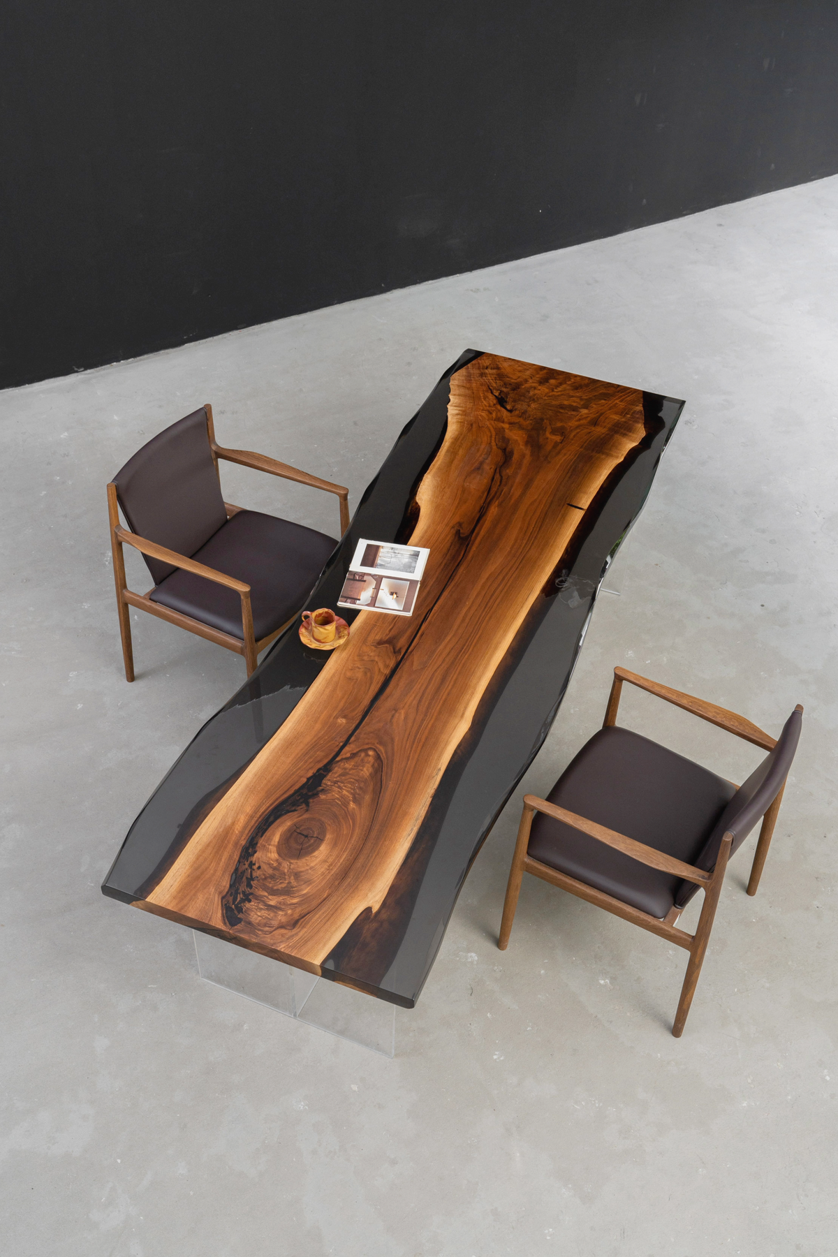 Overhead view of the Paradox Table, an executive desk with two modern office chairs, showcasing the epoxy edges.