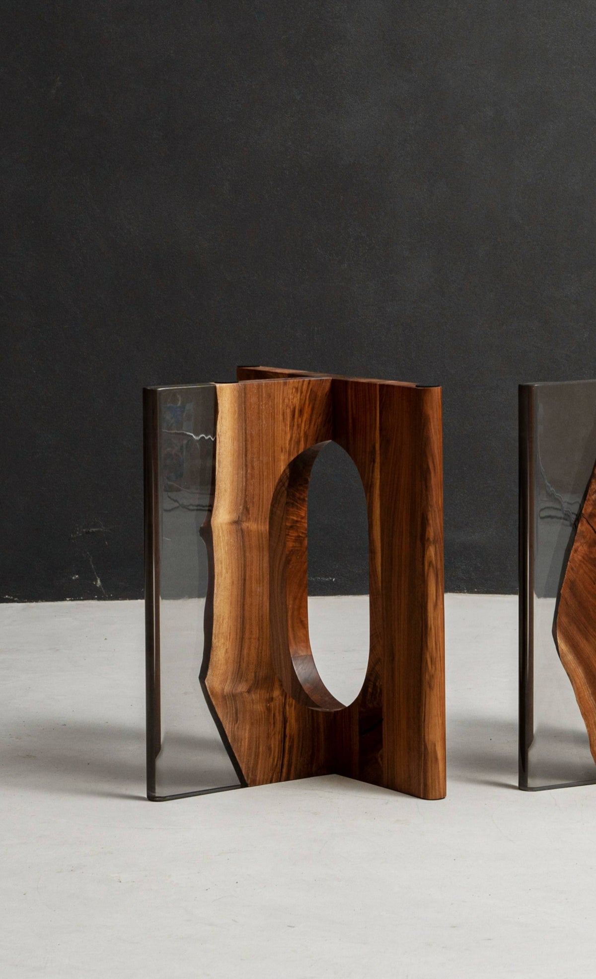 Sculptural black walnut table base with architectural pillar form, designed as a luxury foundation for statement dining tables.