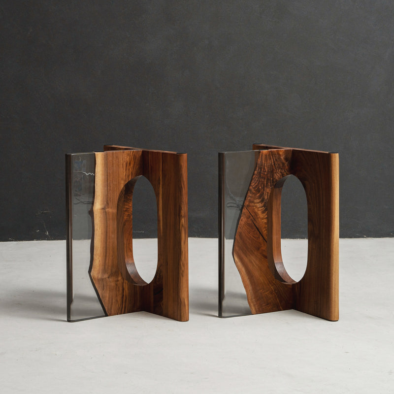 Pillars of Symposium table base featuring sculptural column forms and strong architectural support in black walnut and clear resin