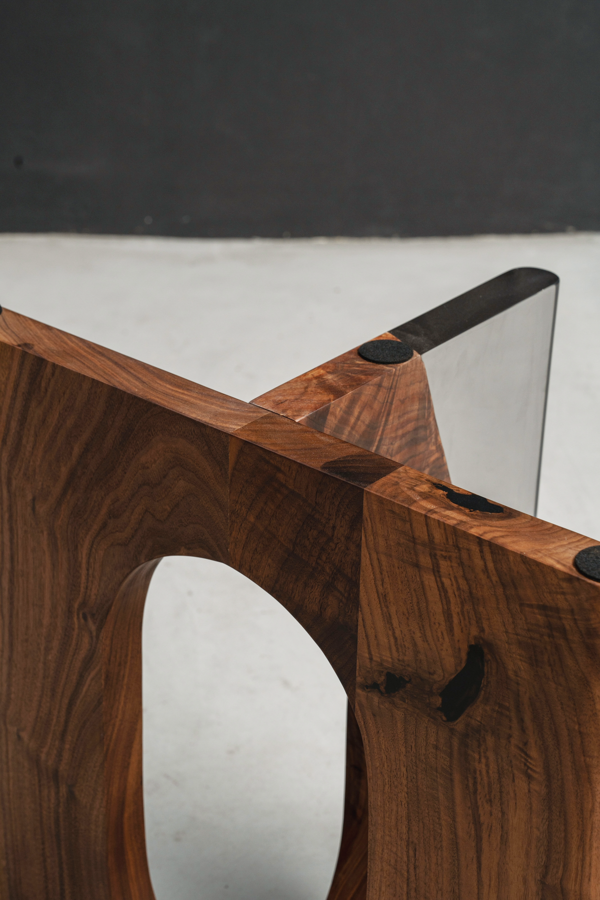 Detailed shot of Symposium top edge, highlighting black walnut joinery and wood grain details.