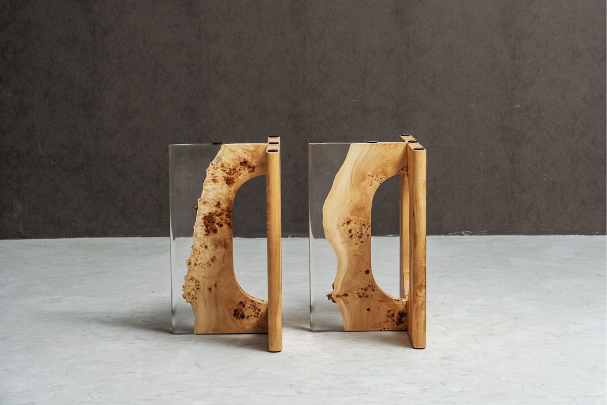 Dual Symposium bases in minimalist setting, highlighting poplar wood and clear epoxy structure.