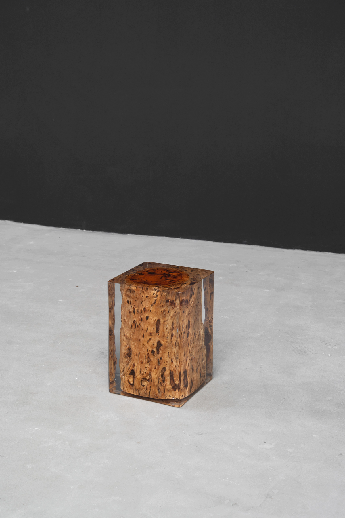 Dynamic angle of camphor wood resin furniture functioning as both stool and side table.