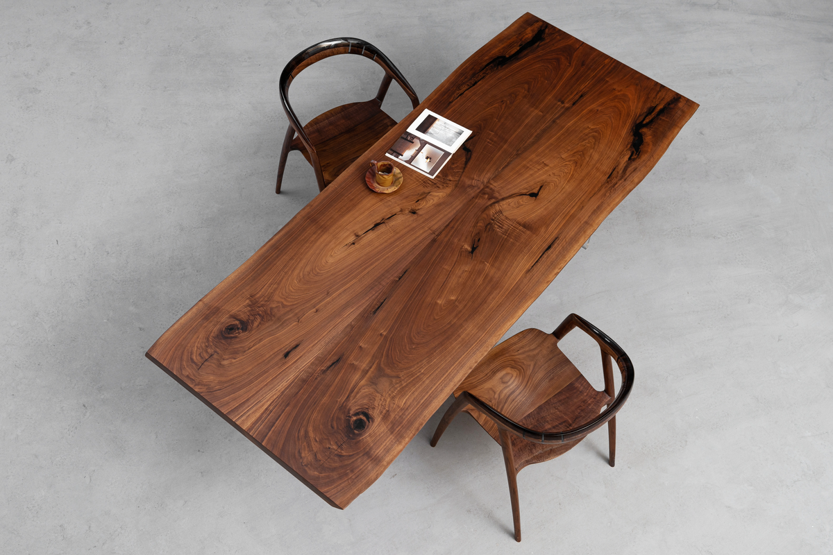 Overhead view of the Resonance Table in black walnut, showcasing its book-matched grain from above.