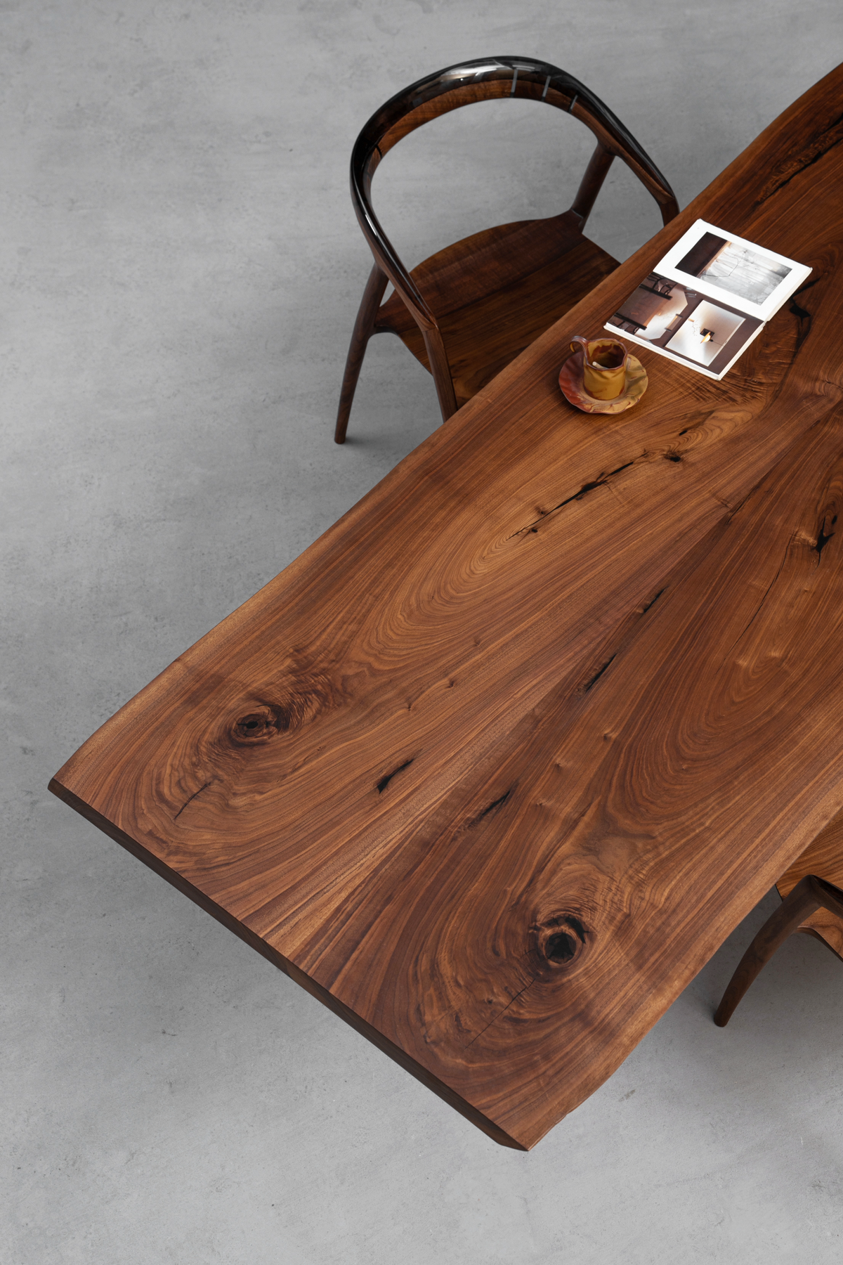 Overhead corner shot looking down at the table end, showcasing wood grain and edge details